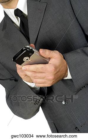 Picture - Mid section view of a businessman using a personal data assistant. Fotosearch