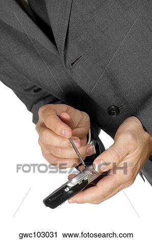 Mid section view of a businessman using a personal data assistant View Large Photo Image Stock Image - Mid section view of a businessman using a personal data assistant. Fotosearch