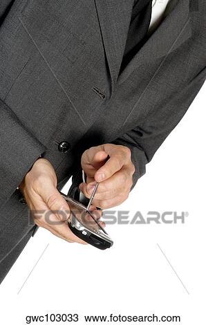Stock Image - Mid section view of a businessman using a personal data assistant. Fotosearch