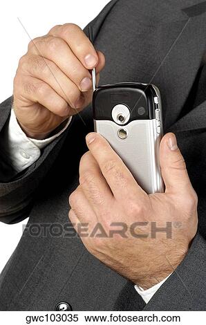 Stock Photography - Mid section view of a businessman using a personal data assistant. Fotosearch