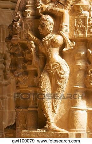 Statue carved on the wall of a temple, Jaisalmer, Rajasthan, India View Large Photo Image Stock Photo - Statue carved on the wall of a temple, Jaisalmer, Rajasthan, India. Fotosearch
