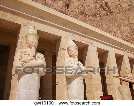 Stock Image - Low angle view of sculpture engraved on the columns of a building, Egypt. Fotosearch