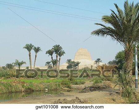 Palm trees in front of a pyramid View Large Photo Image Stock Photo - Palm trees in front of a pyramid. Fotosearch