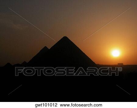 Stock Image - Silhouette of pyramids at sunset, Giza Pyramids, Giza, Cairo, Egypt. Fotosearch