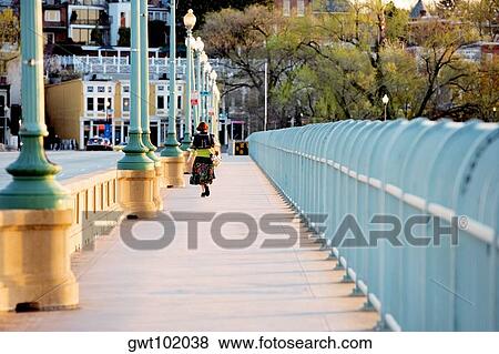Rear view of a woman walking across the Key Bridge, Washington DC, USA View Large Photo Image Stock Photo - Rear view of a woman walking across the Key Bridge, Washington DC, USA. Fotosearch