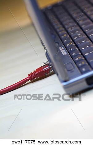 Stock Photography - Close-up of a computer cable plugged into a laptop. Fotosearch