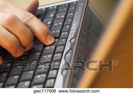 Close-up of a person's fingers using a laptop View Large Photo Image Stock Photograph - Close-up of a person's fingers using a laptop. Fotosearch