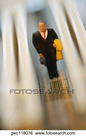 Stock Photograph - Close-up of the figurine of a businessman on a circuit board. Fotosearch