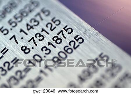 Stock Photograph - Close-up of a ruler with a conversion table. Fotosearch
