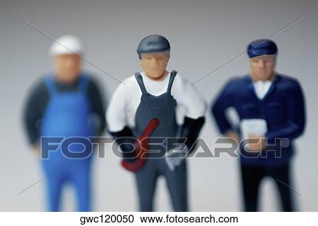 Close-up of three human figurines View Large Photo Image Stock Image - Close-up of three human figurines. Fotosearch