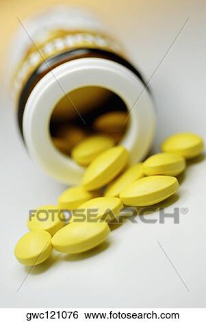 Close-up of pills spilt out of a bottle View Large Photo Image Stock Photograph - Close-up of pills spilt out of a bottle. Fotosearch