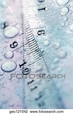 Close-up of rulers in water View Large Photo Image Stock Image - Close-up of rulers in water. Fotosearch