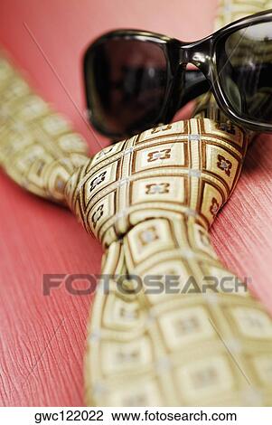 Close-up of a pair of sunglasses and a tie View Large Photo Image Stock Image - Close-up of a pair of sunglasses and a tie. Fotosearch