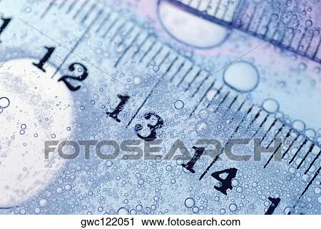 Close-up of a ruler in water View Large Photo Image Stock Image - Close-up of a ruler in water. Fotosearch