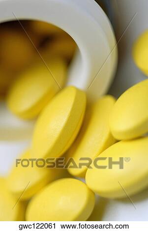 Close-up of pills spilt out of a bottle View Large Photo Image Stock Image - Close-up of pills spilt out of a bottle. Fotosearch