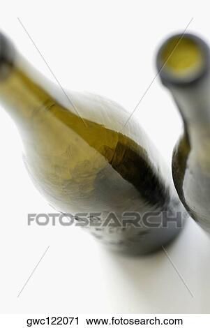 Stock Image - Close-up of two empty beer bottles. Fotosearch