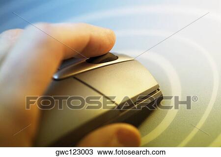 Stock Image - Close-up of a human hand using a computer mouse. Fotosearch