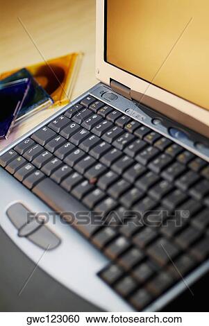 Close-up of a laptop with three CD's View Large Photo Image Stock Image - Close-up of a laptop with three CD's. Fotosearch