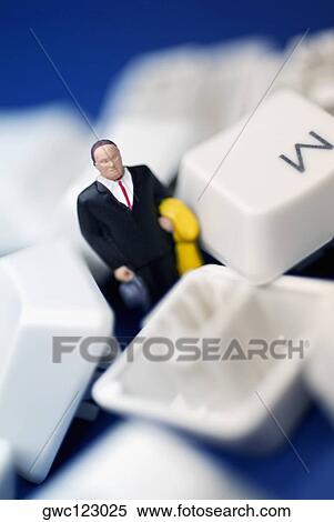 Close-up of the figurine of a businessman surrounded by computer keys View Large Photo Image Stock Photography - Close-up of the figurine of a businessman surrounded by computer keys. Fotosearch