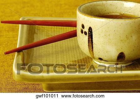 Close-up of a bowl of soy sauce with chopsticks on a serving tray View Large Photo Image Stock Image - Close-up of a bowl of soy sauce with chopsticks on a serving tray. Fotosearch