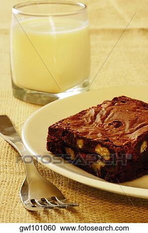 Stock Image - Close-up of a brownie and a glass of milk. Fotosearch