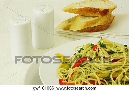 Stock Photograph - Close-up of a plate of noodles near a salt and pepper shaker. Fotosearch