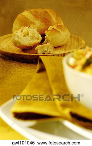 Stock Photograph - Close-up of buns on a wooden plate. Fotosearch