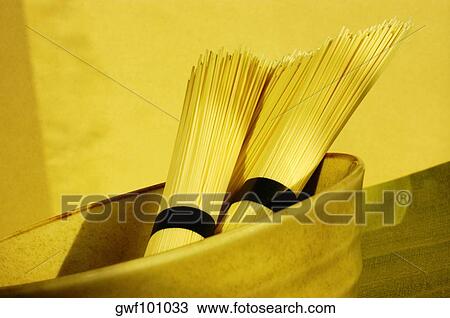 Stock Image - Close-up of two bundles of raw spaghetti. Fotosearch
