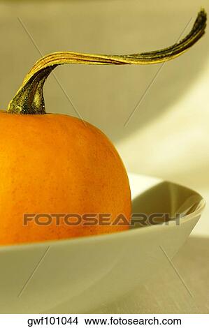 Picture - High angle view of a pumpkin in a bowl. Fotosearch