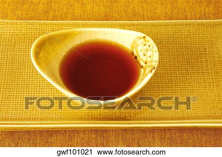 Stock Image - High angle view of soy sauce in a bowl. Fotosearch