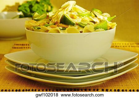 Close-up of a bowl of pasta on a stack of plates View Large Photo Image Stock Photo - Close-up of a bowl of pasta on a stack of plates. Fotosearch