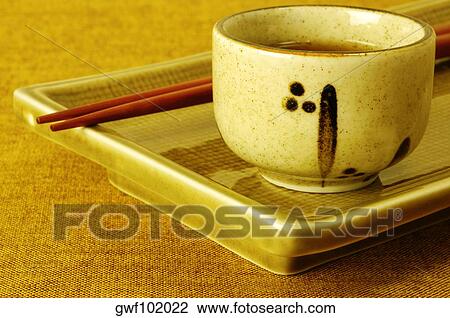 Close-up of a bowl of soy sauce with chopsticks on a serving tray View Large Photo Image Stock Image - Close-up of a bowl of soy sauce with chopsticks on a serving tray. Fotosearch