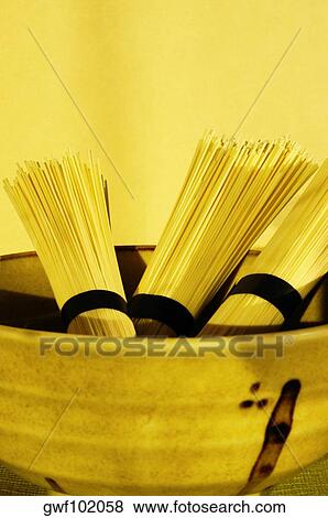 Close-up of raw spaghetti in a bowl View Large Photo Image Stock Photo - Close-up of raw spaghetti in a bowl. Fotosearch