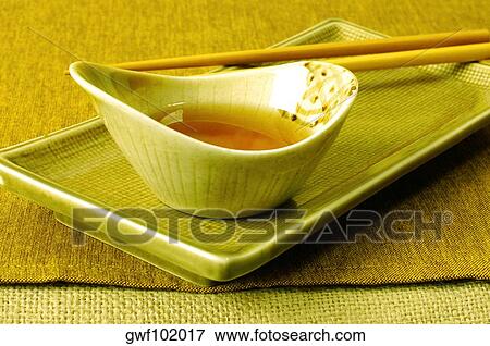 Close-up of soy sauce in a bowl with a pair of chopsticks View Large Photo Image Stock Photo - Close-up of soy sauce in a bowl with a pair of chopsticks. Fotosearch