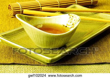 High angle view of soy sauce in a bowl with a pair of chopsticks View Large Photo Image Picture - High angle view of soy sauce in a bowl with a pair of chopsticks. Fotosearch