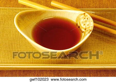 High angle view of soy sauce in a bowl with a pair of chopsticks View Large Photo Image Stock Image - High angle view of soy sauce in a bowl with a pair of chopsticks. Fotosearch