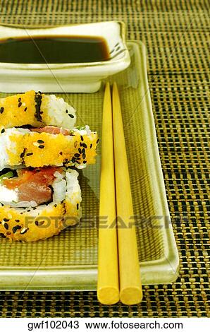 Stock Image - High angle view of sushi on a serving tray with a pair of chopsticks. Fotosearch