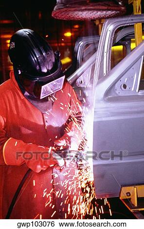 Automobile factory mechanic working on chassis in a shower of sparks View Large Photo Image Stock Photograph - Automobile factory mechanic working on chassis in a shower of sparks. Fotosearch