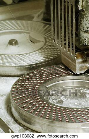Close-up of a capsule filling machine at a pharmaceutical factory, Los Angeles, California, USA View Large Photo Image Stock Image - Close-up of a capsule filling machine at a pharmaceutical factory, Los Angeles, California, USA. Fotosearch