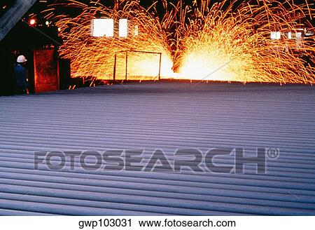 Stock Image - Close-up of a metal sheet in a steel mill. Fotosearch