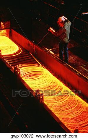 High angle view of a foundry worker examining molten metal, Illinois, USA View Large Photo Image Stock Image - High angle view of a foundry worker examining molten metal, Illinois, USA. Fotosearch