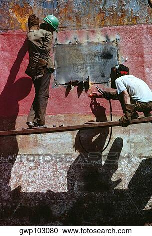 Low angle view of two men welding a tanker, Cebu, Philippines View Large Photo Image Stock Image - Low angle view of two men welding a tanker, Cebu, Philippines. Fotosearch