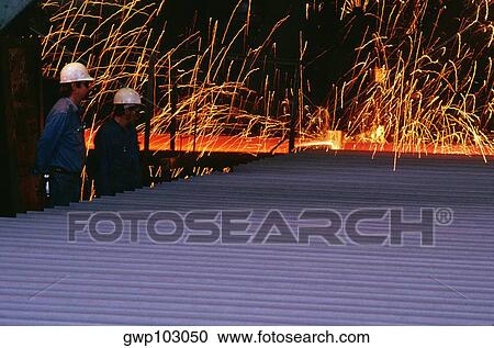 Side profile of two foundry workers standing in a steel mill View Large Photo Image Stock Image - Side profile of two foundry workers standing in a steel mill. Fotosearch