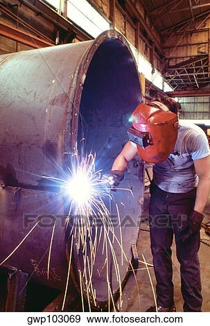 Welder welding a large tank View Large Photo Image Stock Photo - Welder welding a large tank. Fotosearch