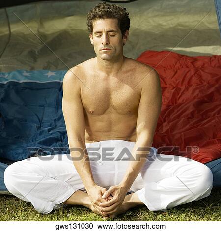 Stock Image - Close-up of a mid adult man meditating. Fotosearch