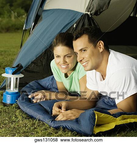 Close-up of a young couple smiling View Large Photo Image Stock Photo - Close-up of a young couple smiling. Fotosearch
