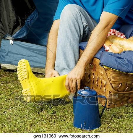 Stock Image - High angle view of a man wearing galoshes. Fotosearch