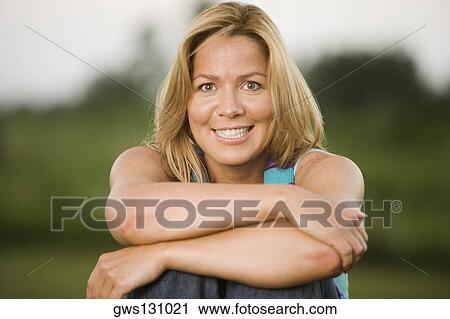 Portrait of a mature woman smiling View Large Photo Image Stock Image - Portrait of a mature woman smiling. Fotosearch