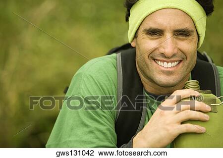 Portrait of a mid adult man holding a water bottle View Large Photo Image Stock Image - Portrait of a mid adult man holding a water bottle. Fotosearch