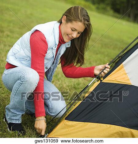 Side profile of a teenage girl putting up a tent View Large Photo Image Stock Photo - Side profile of a teenage girl putting up a tent. Fotosearch